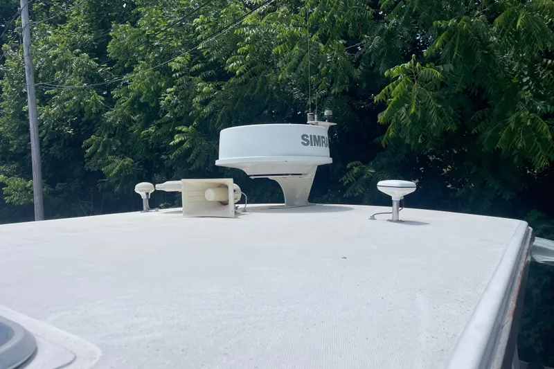 Slide: The Image of Rooftop of 2001 Sabre 36 Express boat with radar equipment, surrounded by lush greenery. - 32