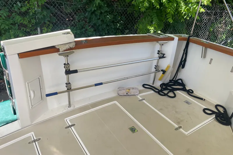 Slide: The Image of 2001 Sabre 36 Express boat deck with storage compartments and cleaning tools. - 34