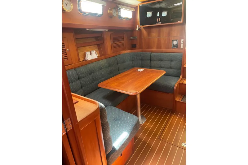Slide: The Image of 2001 Sabre 36 Express yacht interior with wooden dining area and cushioned seating. - 30