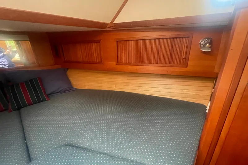 Slide: The Image of Cozy cabin interior of 2001 Sabre 36 Express yacht with wooden paneling and comfortable bedding. - 28