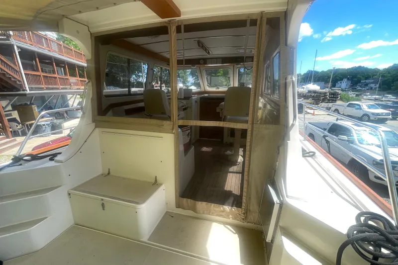 Slide: The Image of 2001 Sabre 36 Express boat interior with seating, dockside view, and clear skies. - 6