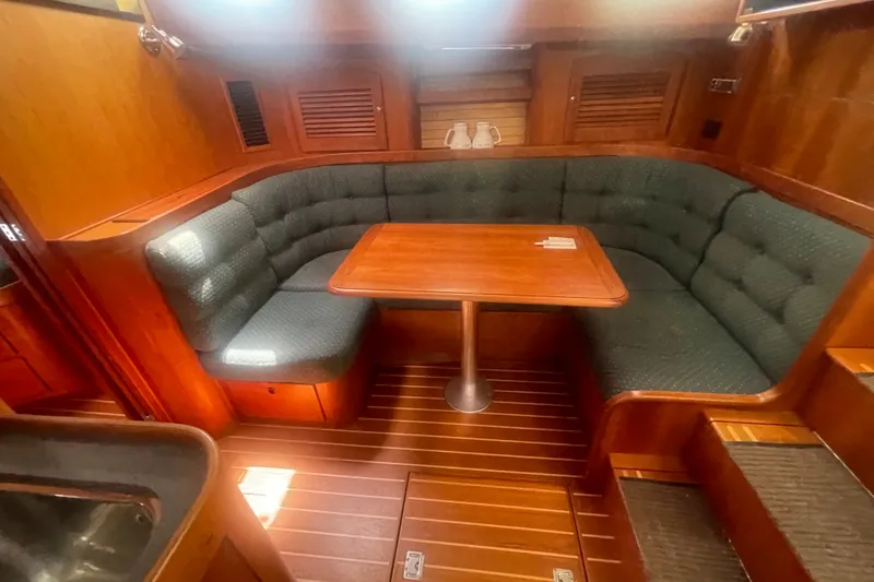 Slide: The Image of Cozy interior of 2001 Sabre 36 Express yacht with cushioned seating and wooden table. - 19