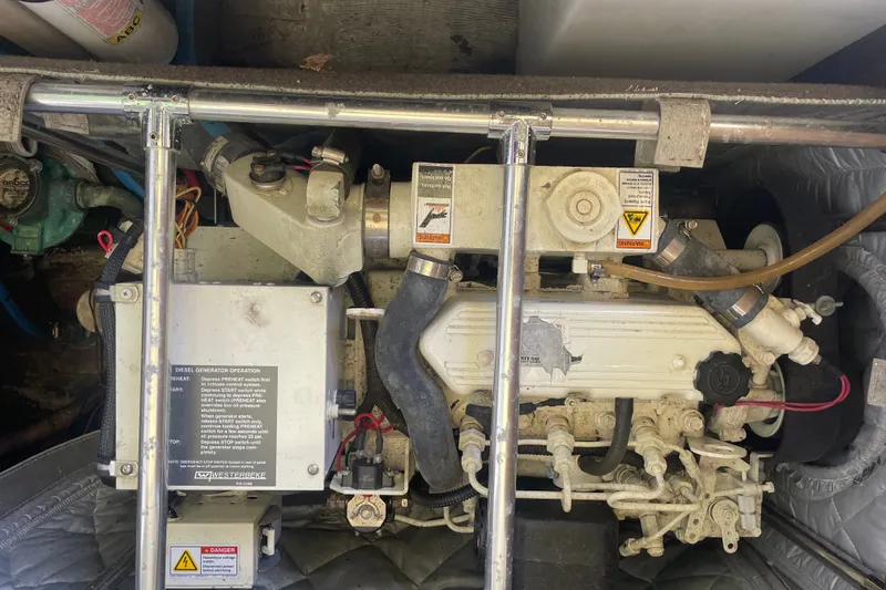 Slide: The Image of Engine compartment of a 2001 Sabre 36 Express boat, featuring a diesel generator. - 40