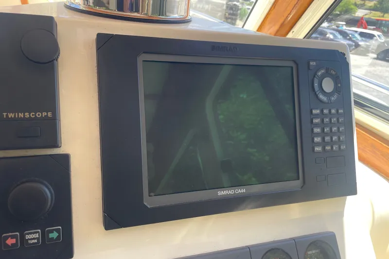 Slide: The Image of Simrad CA44 navigation system on 2001 Sabre 36 Express boat dashboard. - 14