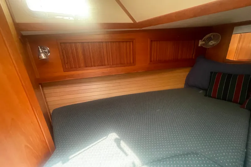 Slide: The Image of Cozy cabin interior of 2001 Sabre 36 Express yacht with wooden paneling and bedding. - 27