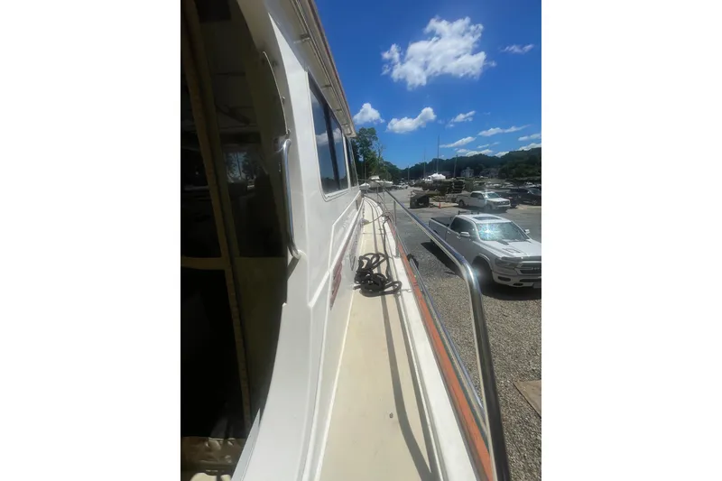 Slide: The Image of Side view of a 2001 Sabre 36 Express yacht docked under a clear blue sky. - 5