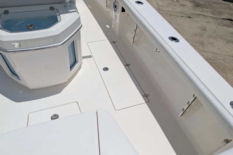Slide: The Image of 2027 Pathfinder 2700 Tournament boat deck with storage compartments and livewell. - 13