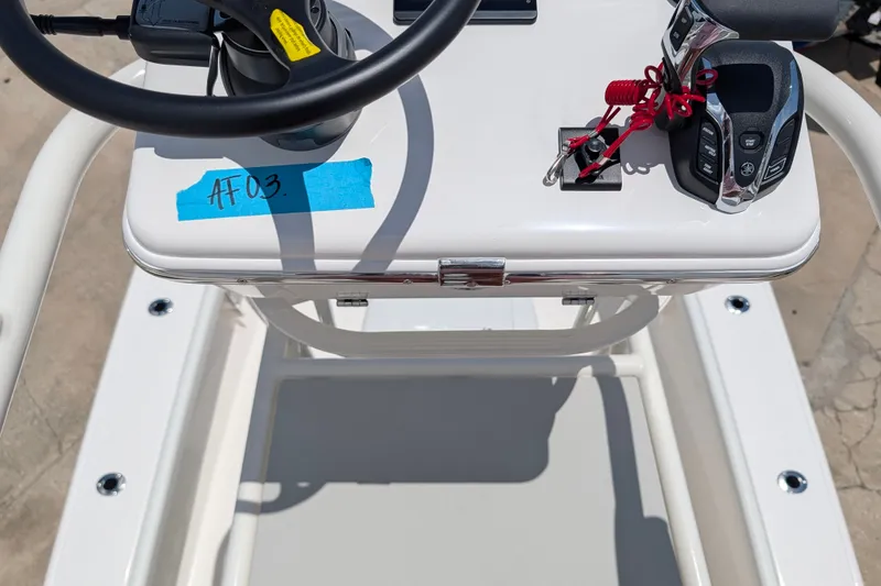 Slide: The Image of 2027 Pathfinder 2700 Tournament boat console with steering wheel and controls. - 54