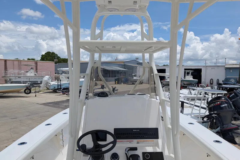 Slide: The Image of 2027 Pathfinder 2700 Tournament boat interior at a marina, showcasing steering and controls. - 24