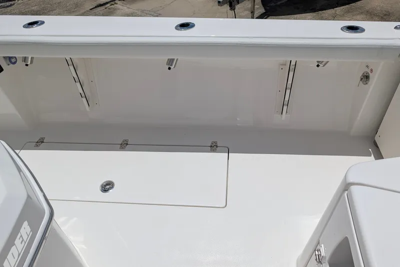 Slide: The Image of 2027 Pathfinder 2700 Tournament boat deck, featuring sleek white design and storage compartments. - 16