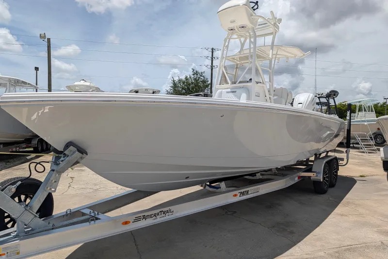The Image of 2027 Pathfinder 2700 Tournament boat on trailer under cloudy sky. - 0