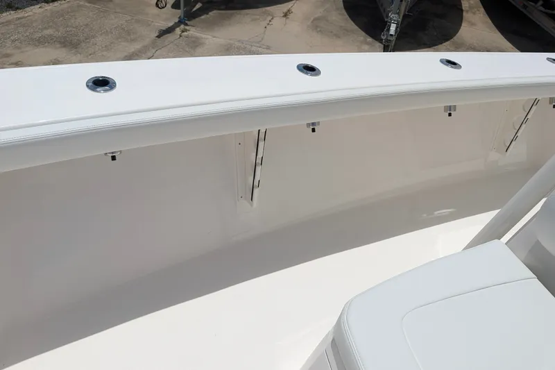Slide: The Image of 2027 Pathfinder 2700 Tournament boat interior with sleek white seating and rod holders. - 37