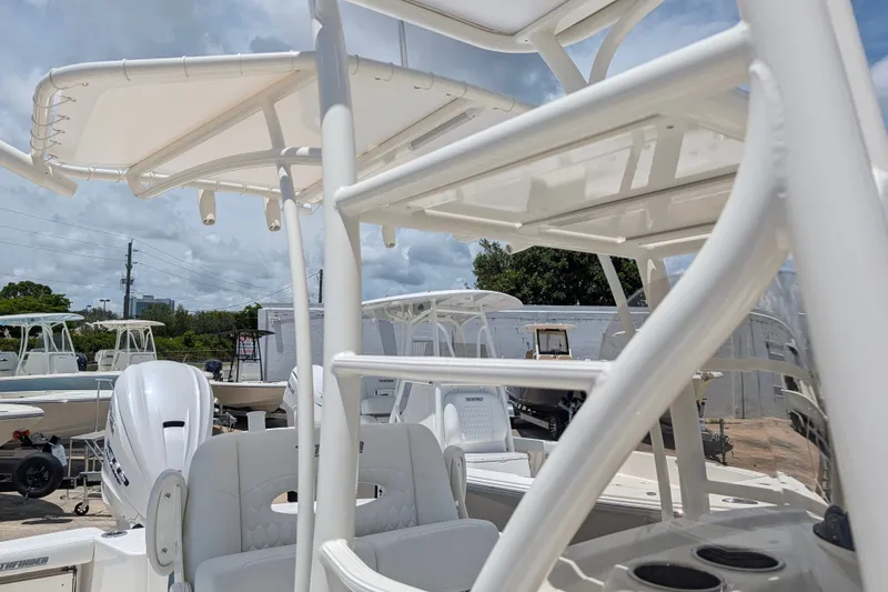 Slide: The Image of 2027 Pathfinder 2700 Tournament boat with T-top and seating, displayed outdoors. - 46