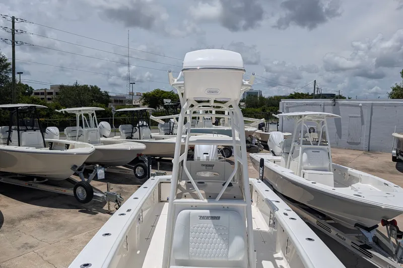 Slide: The Image of 2027 Pathfinder 2700 Tournament boats displayed in a dealership lot under cloudy skies. - 42