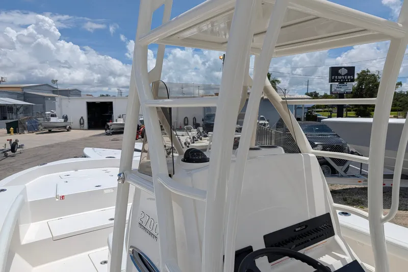 Slide: The Image of 2027 Pathfinder 2700 Tournament boat at a marina under a partly cloudy sky. - 27