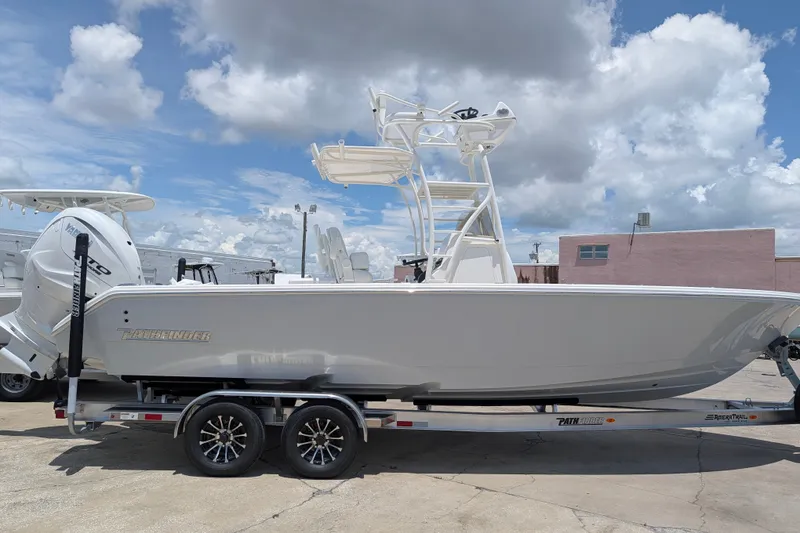 Slide: The Image of 2027 Pathfinder 2700 Tournament boat on trailer under cloudy sky. - 1