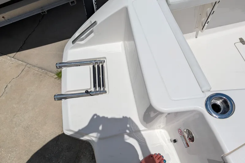Slide: The Image of 2027 Pathfinder 2700 Tournament boat deck with stainless steel ladder and cup holder. - 11