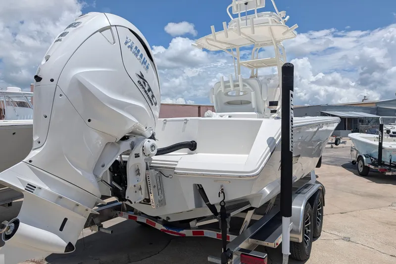 Slide: The Image of 2027 Pathfinder 2700 Tournament boat with Yamaha engine on trailer, under a cloudy sky. - 2