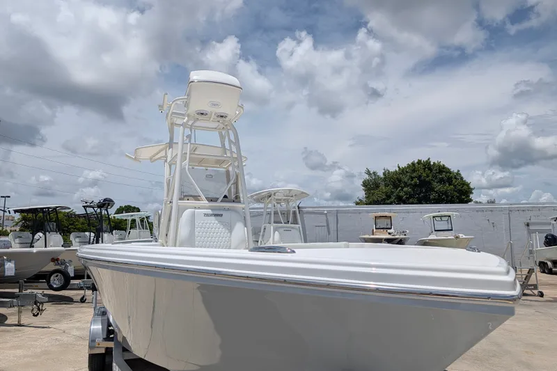Slide: The Image of 2027 Pathfinder 2700 Tournament boat under cloudy sky at a dealership. - 5