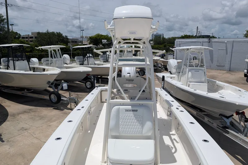 Slide: The Image of 2027 Pathfinder 2700 Tournament boat displayed in a dealership lot under a cloudy sky. - 41