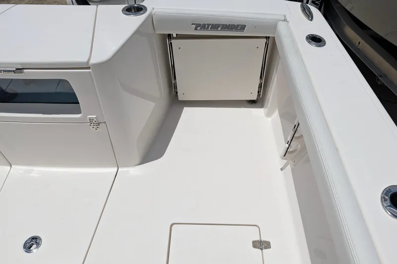 Slide: The Image of 2027 Pathfinder 2700 Tournament boat deck with storage compartments and sleek design. - 19