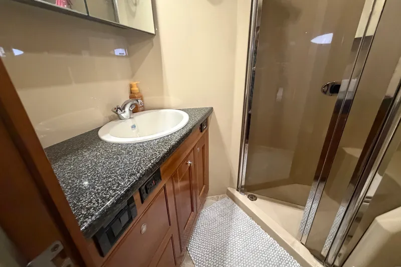Slide: The Image of Luxurious bathroom in 2006 Cruisers Yachts 560 Express with granite countertop and shower. - 19