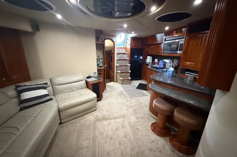 Slide: The Image of Luxurious interior of 2006 Cruisers Yachts 560 Express with plush seating and modern kitchen amenities. - 17
