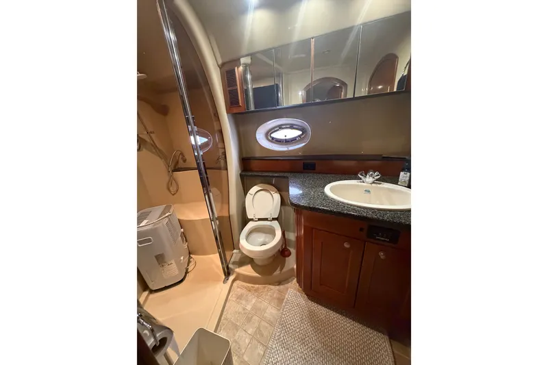 Slide: The Image of Luxurious bathroom in 2006 Cruisers Yachts 560 Express, featuring modern fixtures and elegant design. - 16