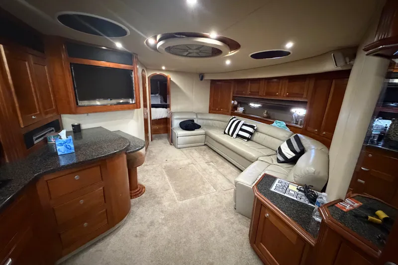 Slide: The Image of Luxurious interior of 2006 Cruisers Yachts 560 Express with plush seating and elegant wood finishes. - 13