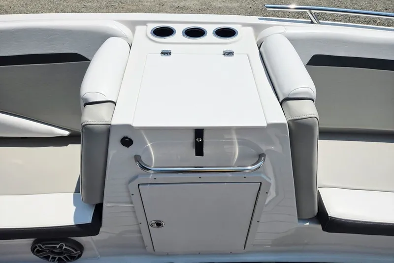 Slide: The Image of 2024 Starcraft SVX 231 OB boat seating area with cup holders and storage compartment. - 18