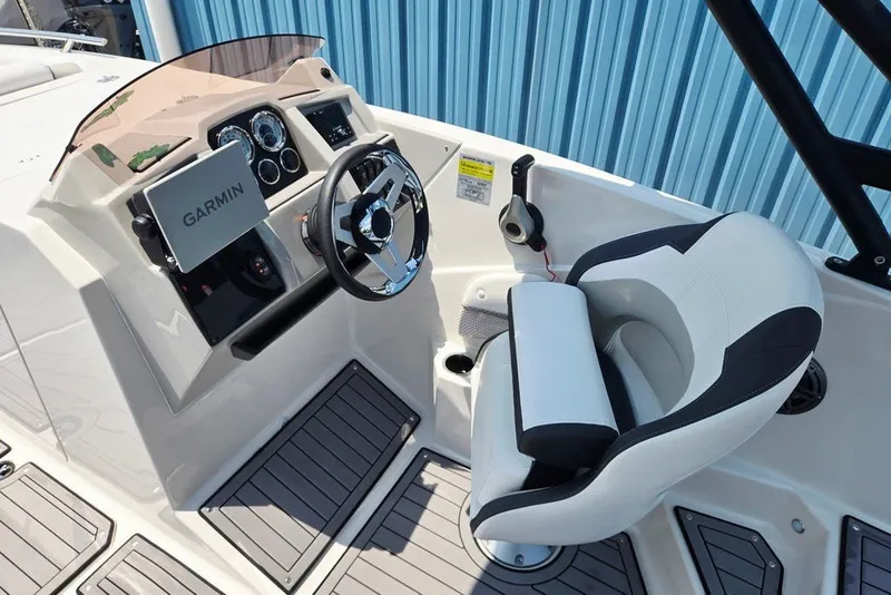 Slide: The Image of 2024 Starcraft SVX 231 OB boat cockpit with Garmin navigation and modern steering wheel. - 23