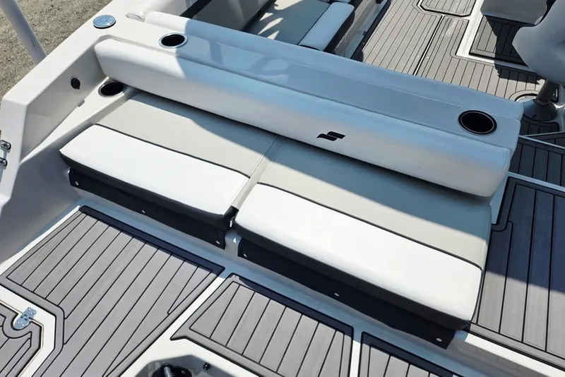 Slide: The Image of 2024 Starcraft SVX 231 OB boat interior with cushioned seating and cup holders. - 48