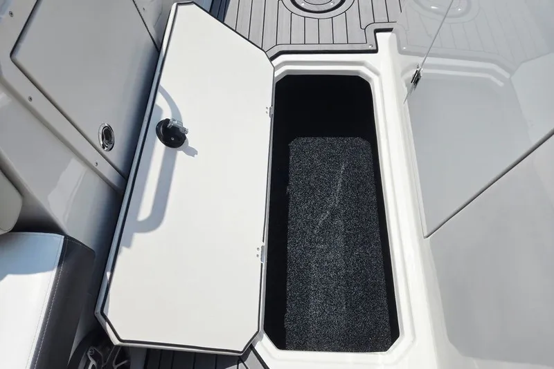 Slide: The Image of 2024 Starcraft SVX 231 OB boat storage compartment with open hatch, showcasing interior space. - 29
