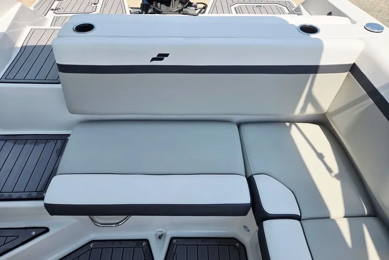 Slide: The Image of 2024 Starcraft SVX 231 OB boat interior with cushioned seating and cup holders. - 53