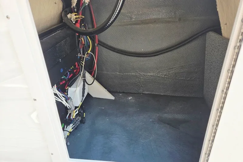 Slide: The Image of 2024 Starcraft SVX 231 OB boat interior wiring and storage compartment. - 30