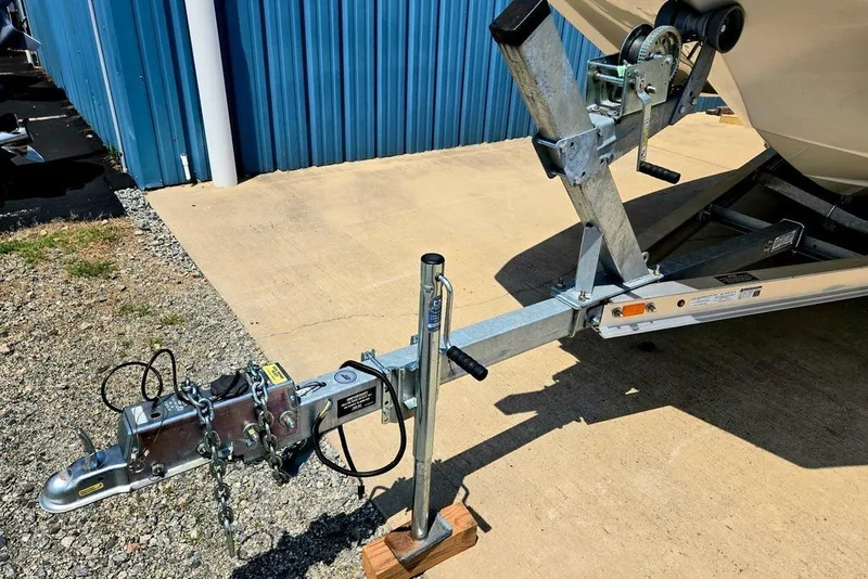 Slide: The Image of Trailer hitch of 2024 Starcraft SVX 231 OB boat, parked on concrete near blue building. - 16