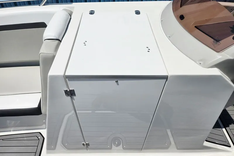 Slide: The Image of 2024 Starcraft SVX 231 OB boat interior, featuring sleek seating and storage compartment. - 24