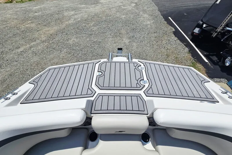 Slide: The Image of 2024 Starcraft SVX 231 OB boat deck with sleek gray padding and cup holders. - 17