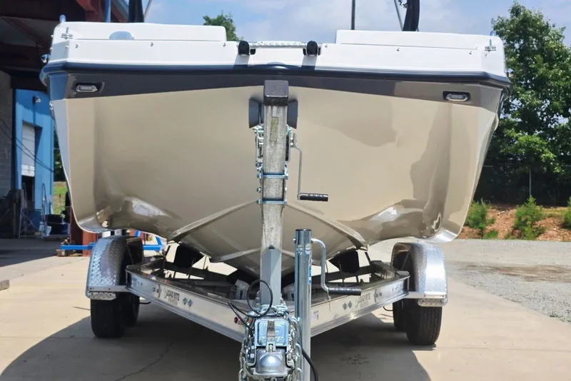 Slide: The Image of 2024 Starcraft SVX 231 OB boat on trailer, front view, outdoors. - 20