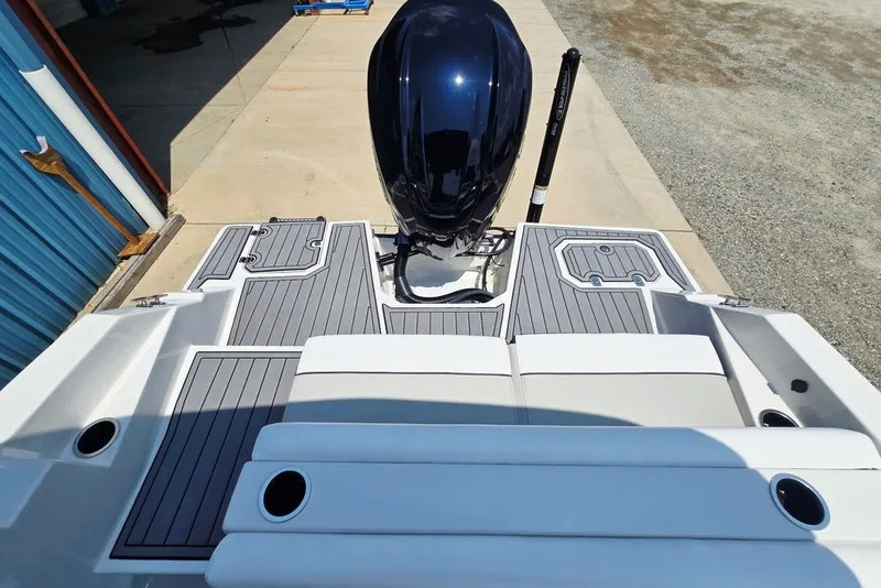 Slide: The Image of 2024 Starcraft SVX 231 OB boat with sleek deck and powerful outboard motor. - 49
