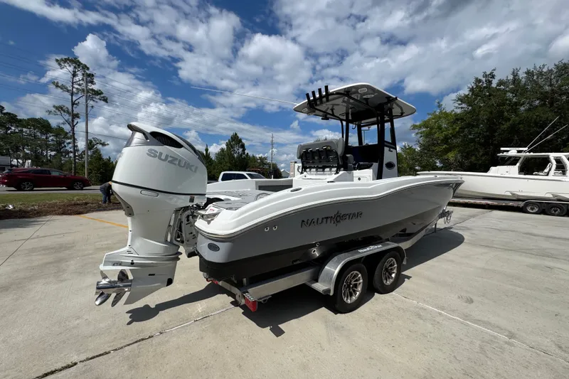 Slide: The Image of 2025 NauticStar 251 Hybrid boat with Suzuki outboard motor on trailer. - 12