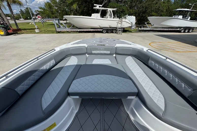Slide: The Image of 2025 NauticStar 251 Hybrid boat interior with luxurious gray seating and diamond-patterned upholstery. - 19