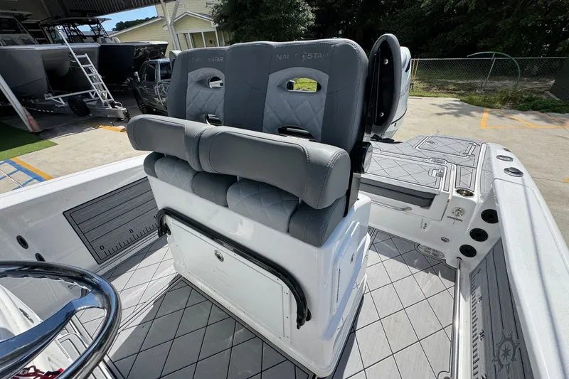 Slide: The Image of 2025 NauticStar 251 Hybrid boat interior with gray cushioned seating and modern design. - 29