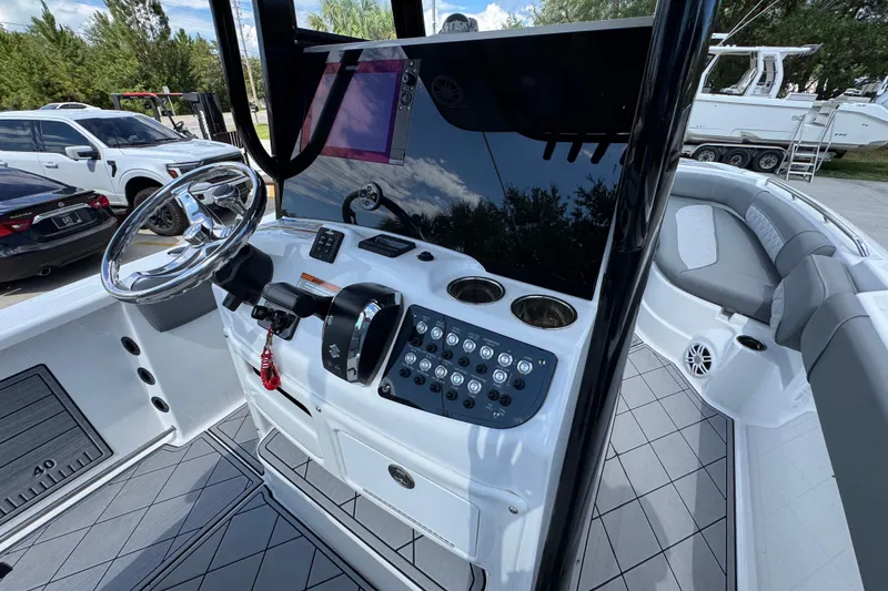 Slide: The Image of 2025 NauticStar 251 Hybrid boat cockpit with steering wheel and control panel. - 37