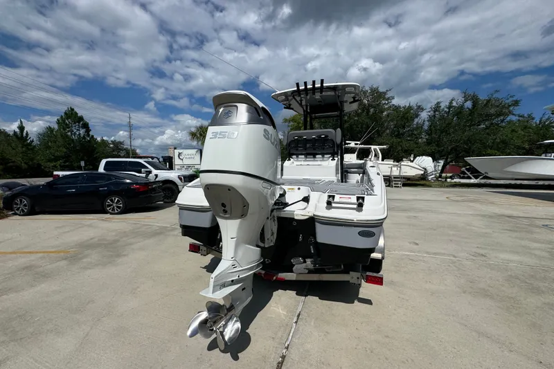Slide: The Image of 2025 NauticStar 251 Hybrid boat with Suzuki 350 outboard motor in a marina setting. - 14