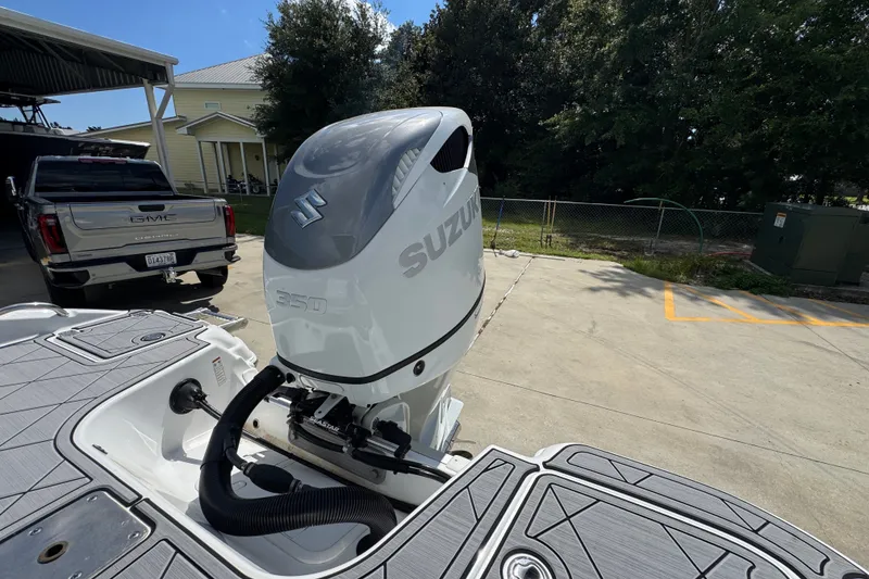 Slide: The Image of 2025 NauticStar 251 Hybrid boat with Suzuki 350 outboard motor in driveway. - 43