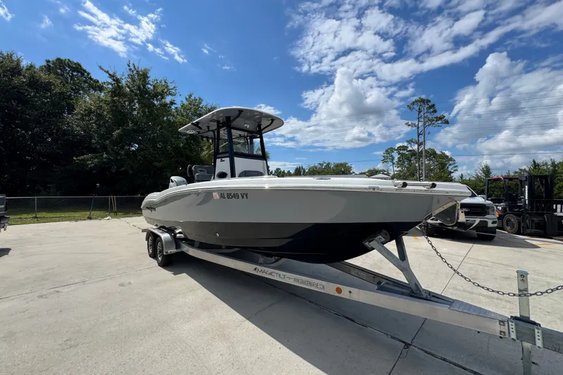 Slide: The Image of 2025 NauticStar 251 Hybrid boat on trailer under a partly cloudy sky. - 8