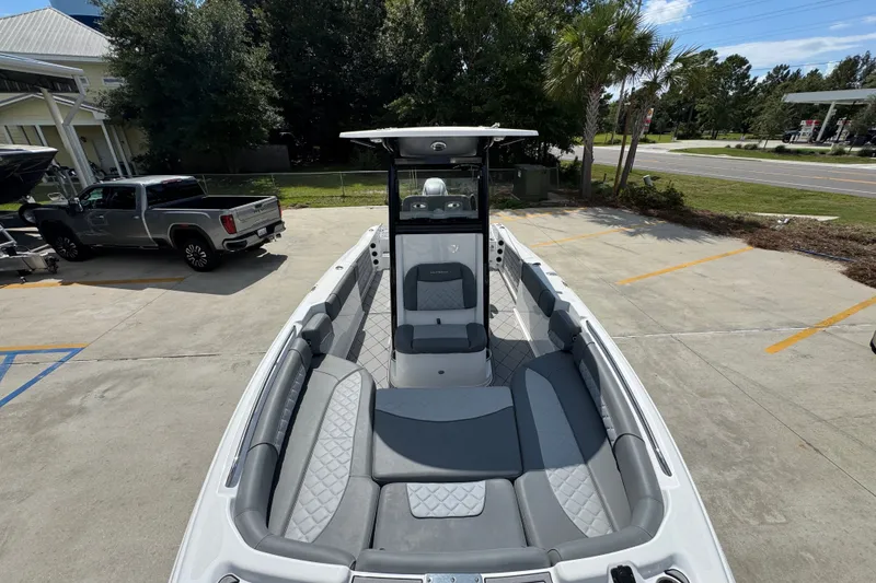 Slide: The Image of 2025 NauticStar 251 Hybrid boat with sleek seating, parked outdoors. - 24