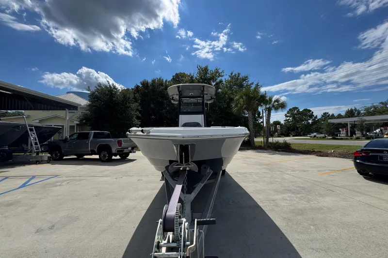 Slide: The Image of 2025 NauticStar 251 Hybrid boat on trailer under a sunny sky. - 6