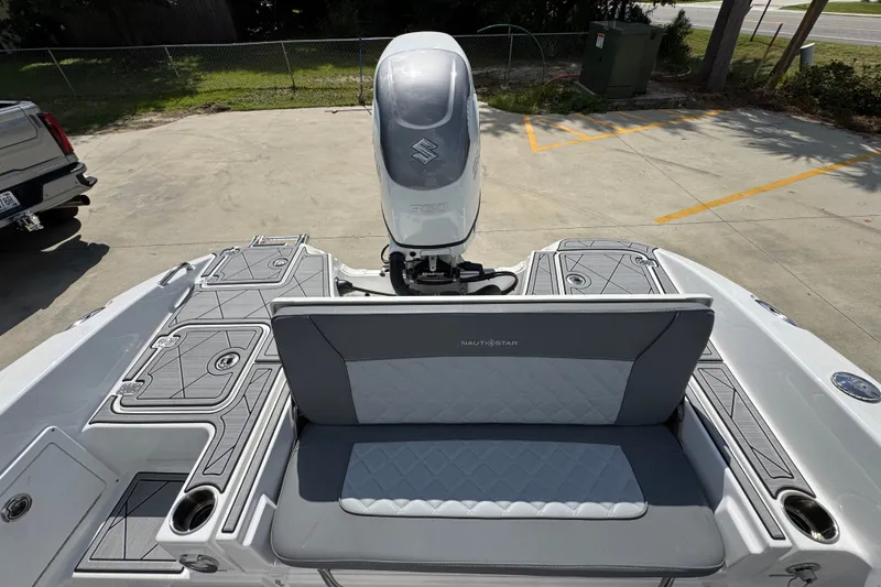 Slide: The Image of 2025 NauticStar 251 Hybrid boat with Suzuki outboard motor, featuring sleek seating and deck design. - 42